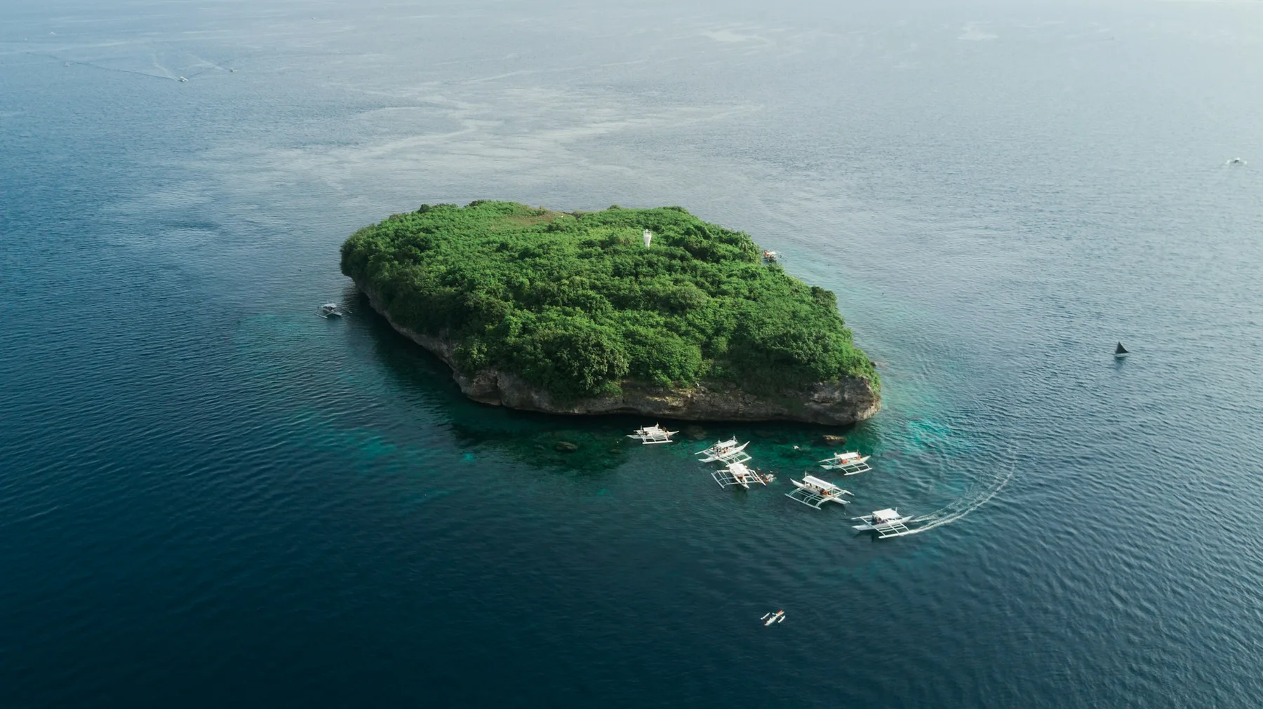 Pescador Island surrounded by the deep blue sea off Moalboal