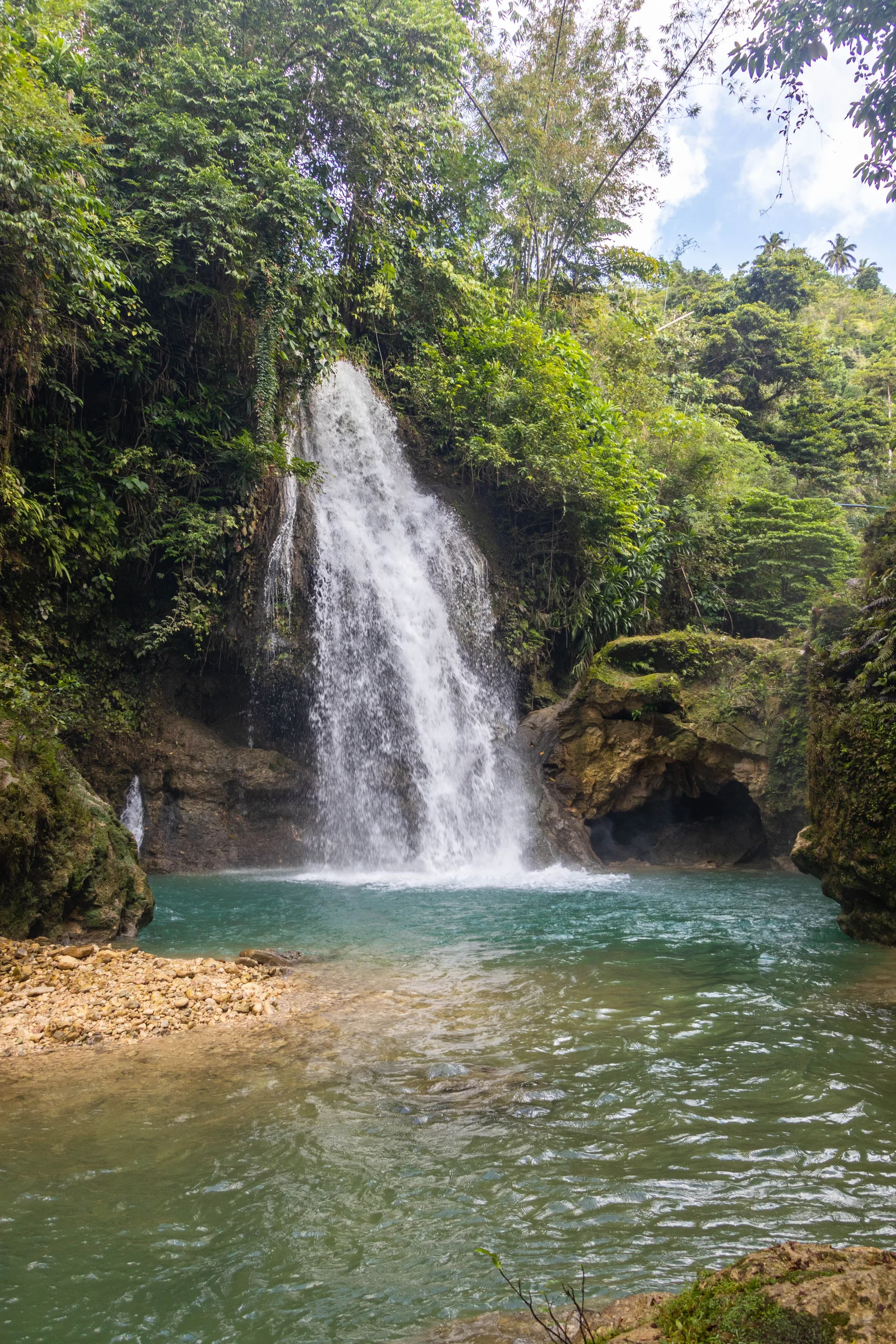 Kawasan waterfall surrounded by tropical greenery